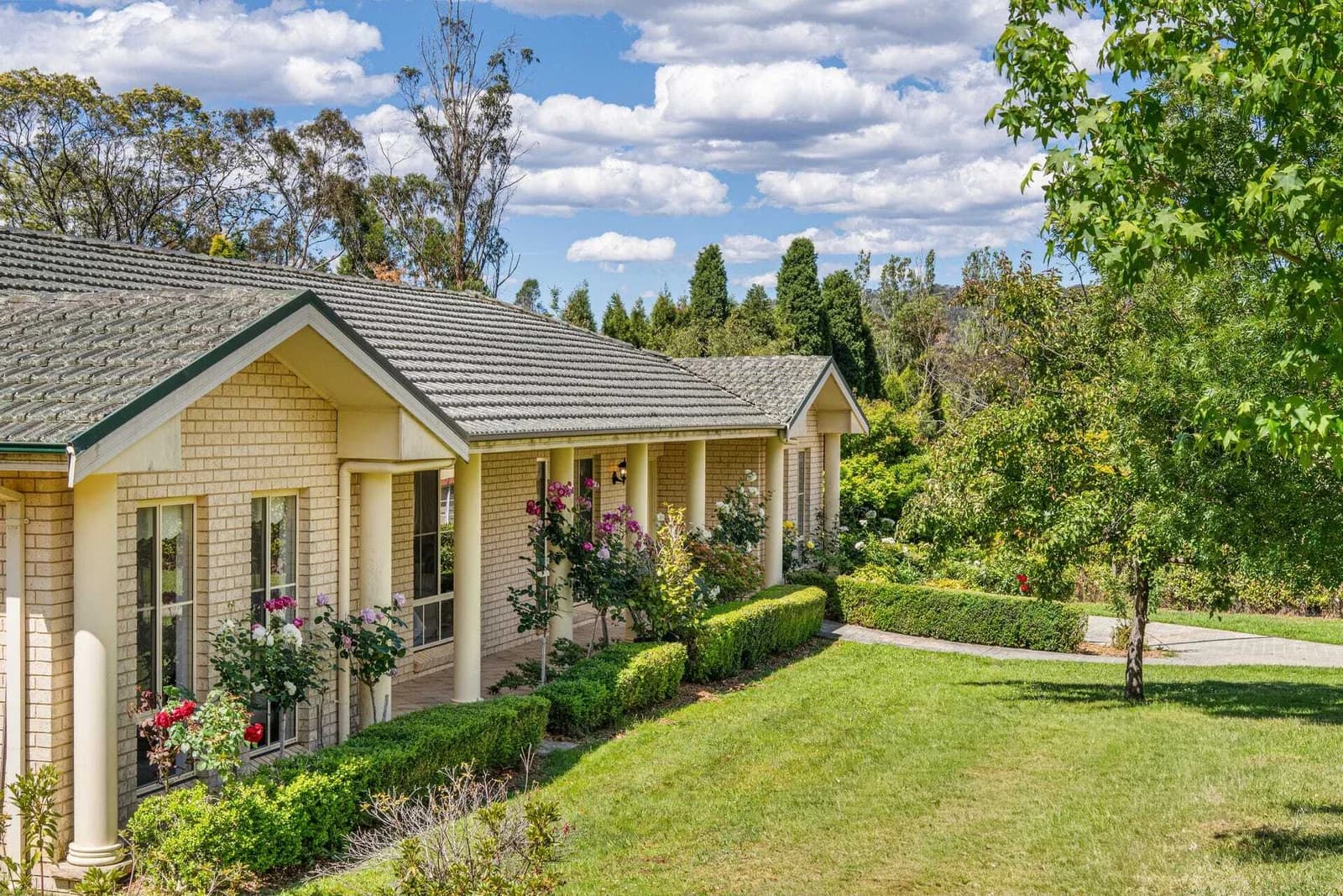 Current brick front exterior and established landscaped garden
