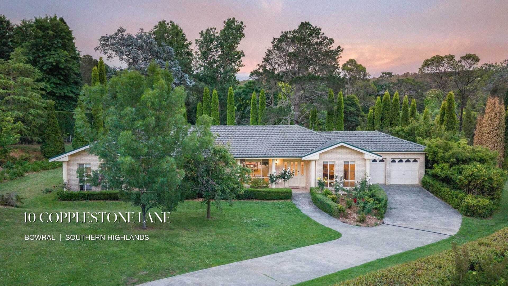10 Copplestone Lane, Bowral at dusk, showing the single-level house, front lawn and curved driveway.
